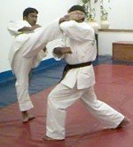 Defender counter-attacks with right roundhouse kick.